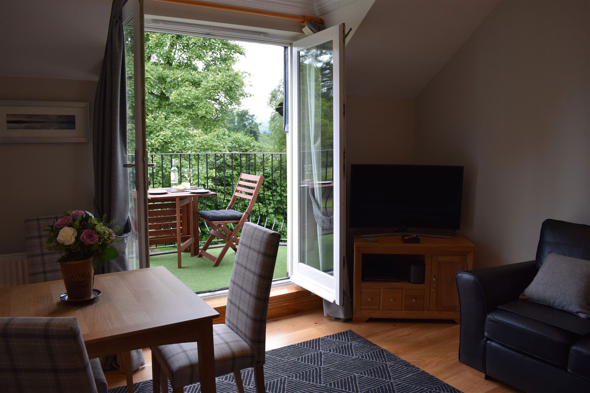 The comfortable lounge at Benoch self-catering apartment leads out through double doors to your own balcony.