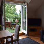 The comfortable lounge at Benoch self-catering apartment leads out through double doors to your own balcony.